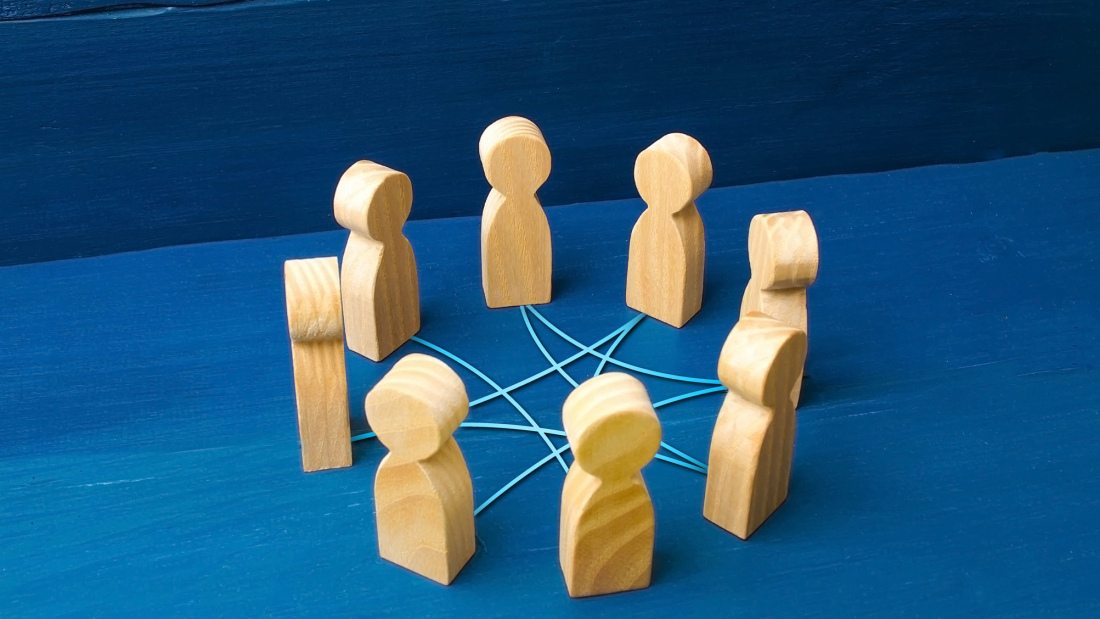 Wood figures in circle connected with string