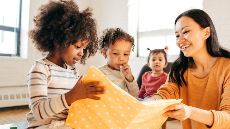 Woman reading with toddlers.