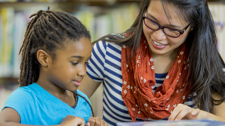 Teacher reading with a student