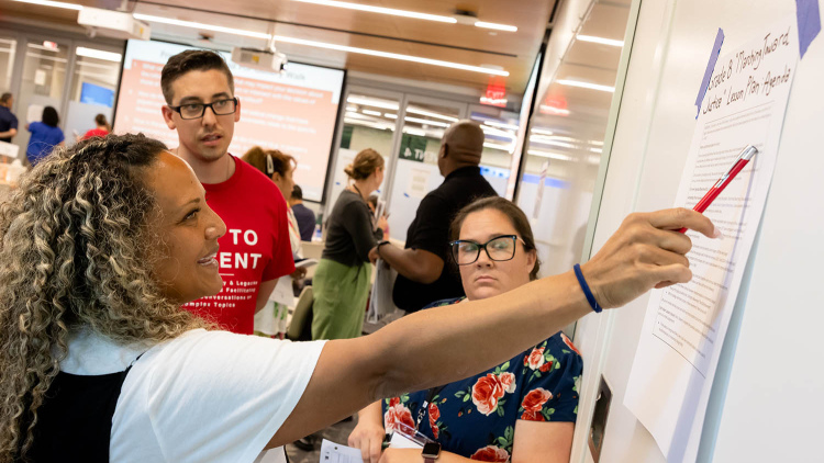 Students pointing to whiteboard