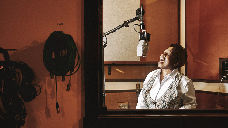 Photo of Candice Crawford-Zakian singing in a studio