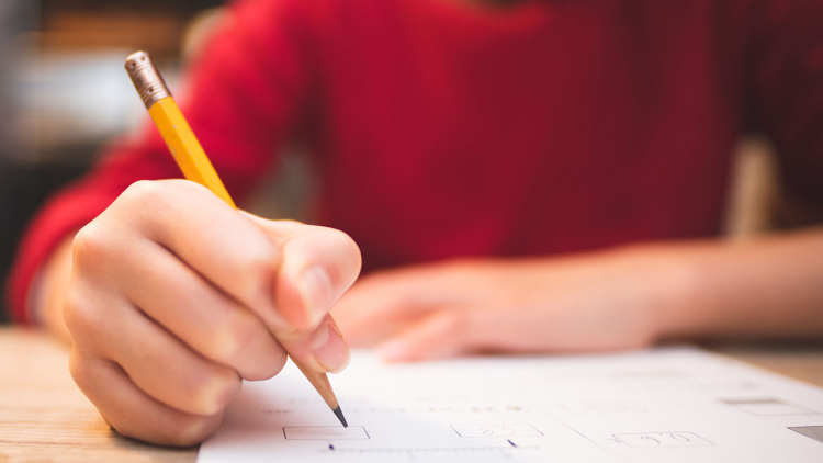 Student with pencil taking test