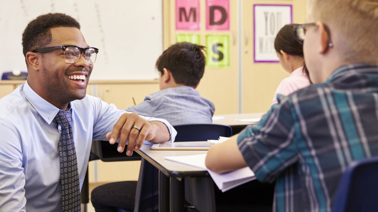 Teacher smiling at student