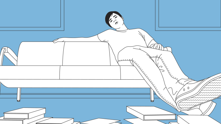 Teen lounging on couch with books on floor