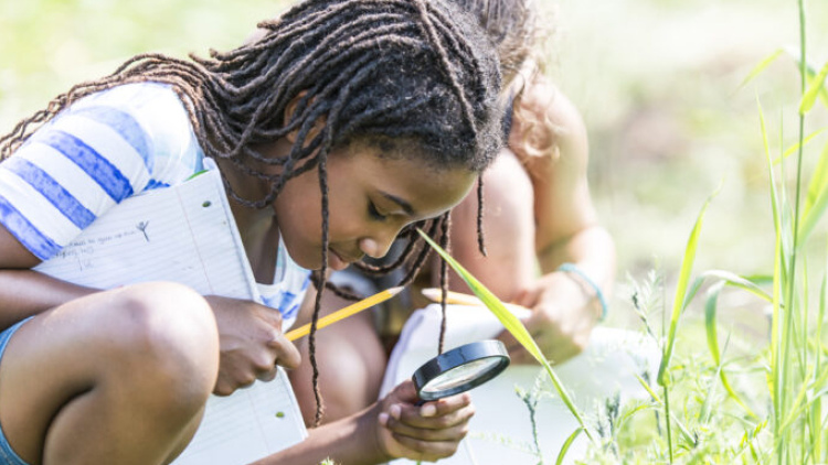 Girl with magnifying glass